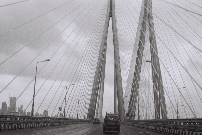 Black and white: the cable-stayed span of the Bandra-Worli Sea Link, a single car crossing