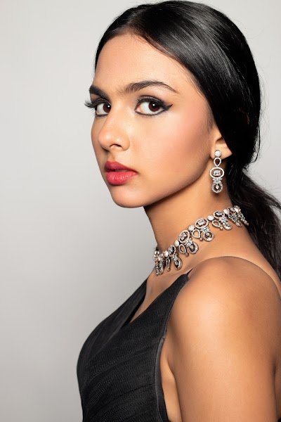 Profile portrait: soft glam makeup, black gown and silver drop earrings