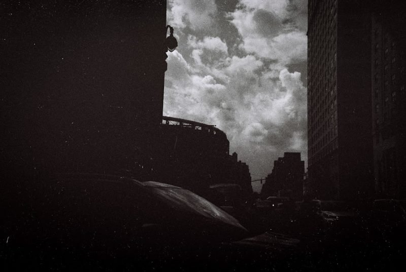 Black and white: dark city towers under a heavy bank of cloud