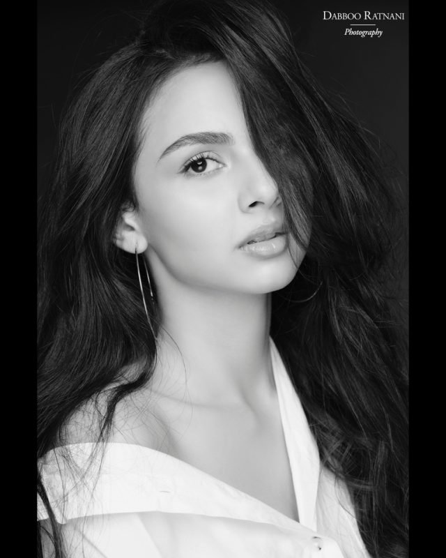 Black and white portrait of Sargam in a white shirt worn off one shoulder