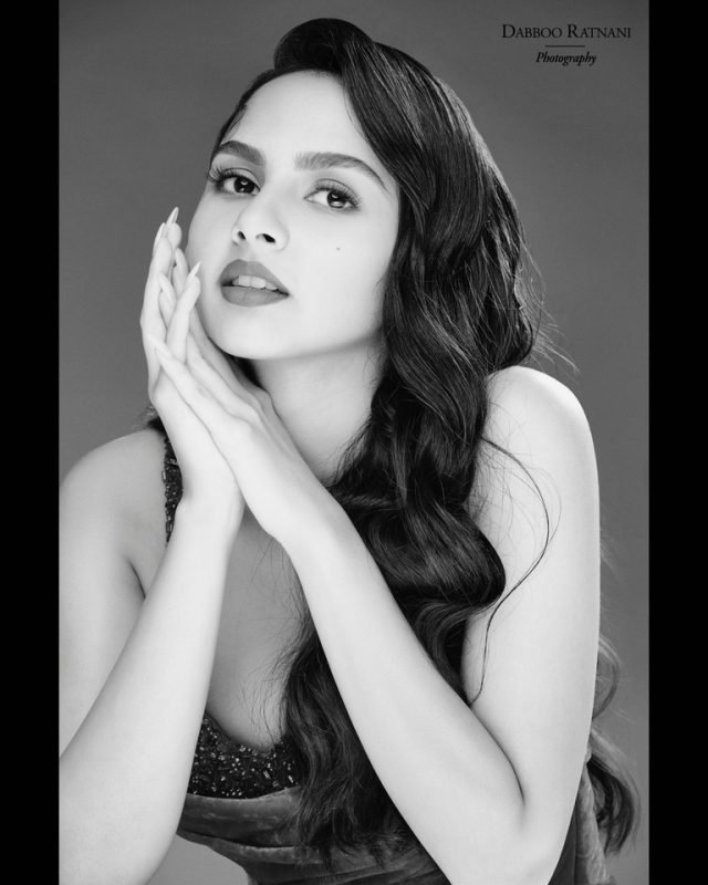 Black and white portrait of Sargam with her hands clasped beneath her chin