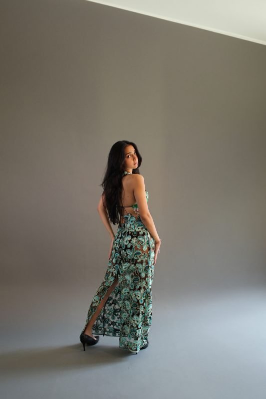 Rea by Rhea lookbook: back view of a green floral maxi skirt with an open back, grey studio
