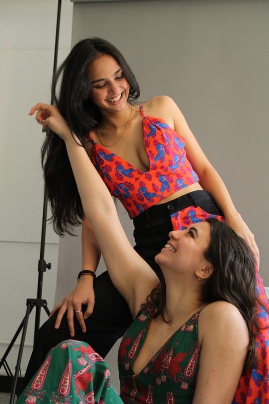 Rea by Rhea lookbook: two models, one seated and one standing, in printed co-ords